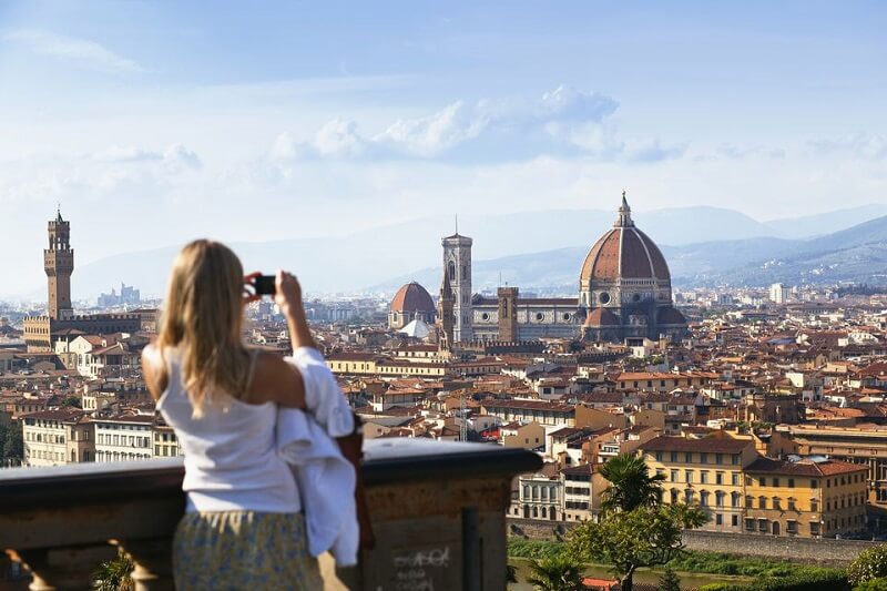Mulher tirando foto na Piazzale Michelangelo em Florença